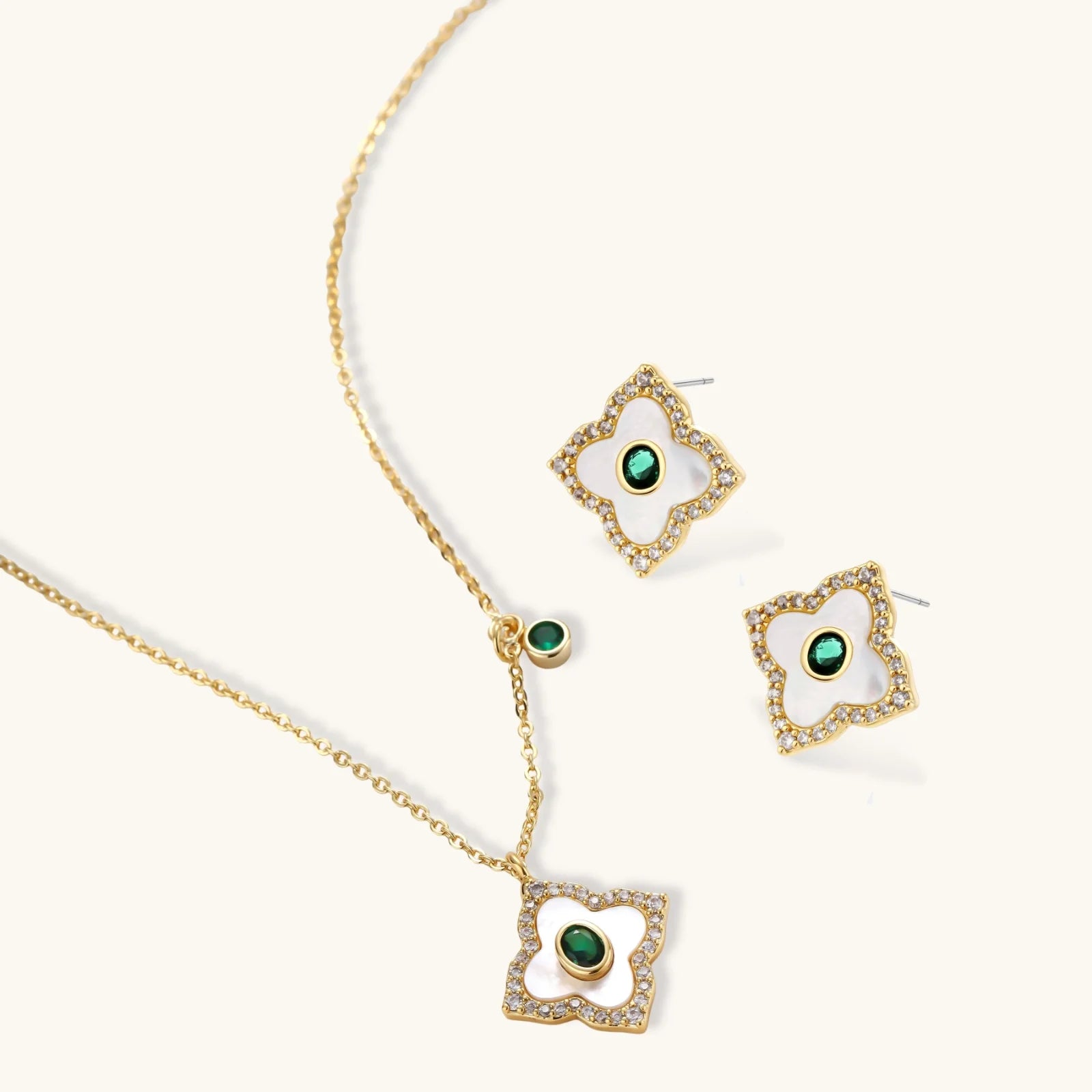Gold-plated jewelry set with diamond-shaped pendants featuring white centers, green stones, and sparkling zirconia borders